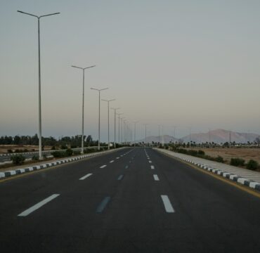 Asphalt road in the Egyptian desert in the evening light.